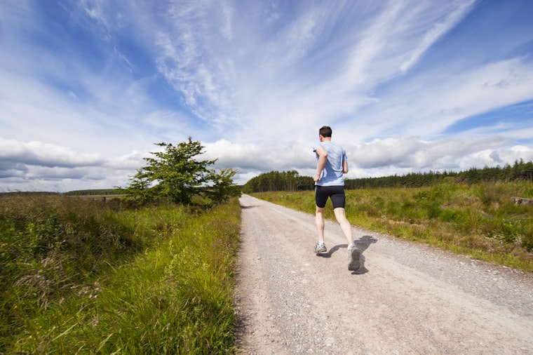 Runner on open road at dawn
